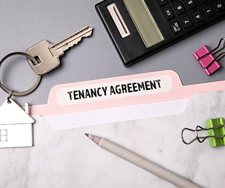 Tenancy Agreement. File folder, stationery and home keys on the office desk